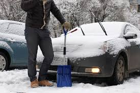 Car being washed in winter conditions with snow and cold weather car care techniques demonstrated
